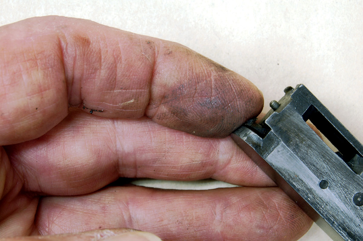 Check for firing-pin tip damage and hardened lube in its recess by pushing with a fingertip. If it moves freely, all is well.